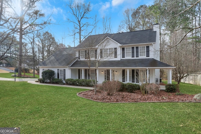 view of front of home with a front yard and covered porch