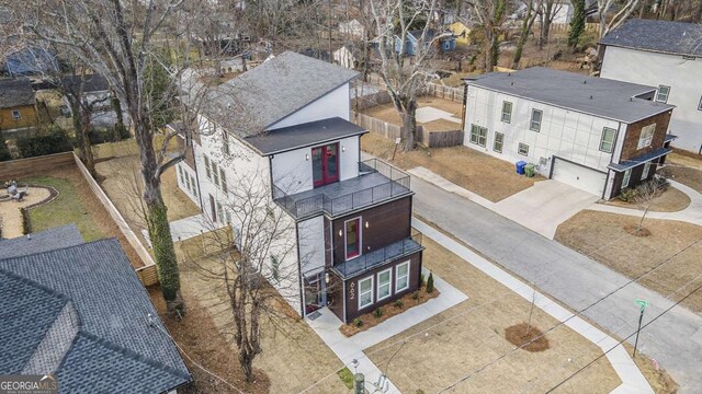 view of front of house with a garage, a front lawn, and central air condition unit