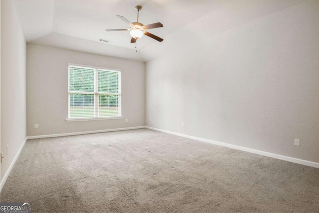 spare room with vaulted ceiling, ceiling fan, and carpet flooring