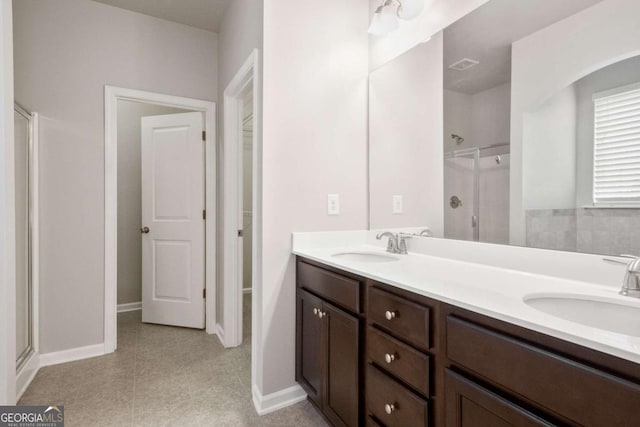 bathroom with vanity and a shower with shower door