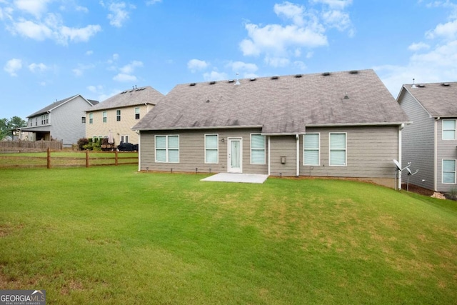 back of property featuring a patio and a lawn