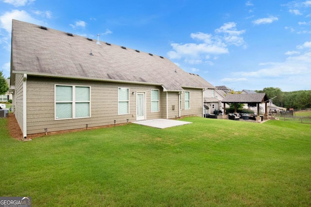 back of property featuring a gazebo, central AC, a lawn, and a patio area