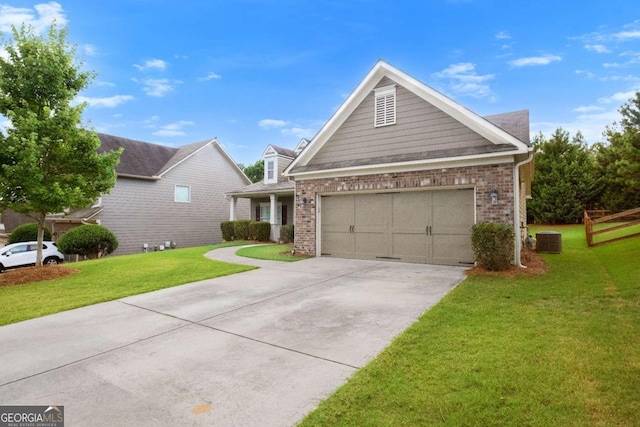 view of front facade with a garage, central AC, and a front yard