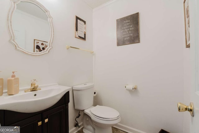 bathroom featuring ornamental molding, vanity, and toilet