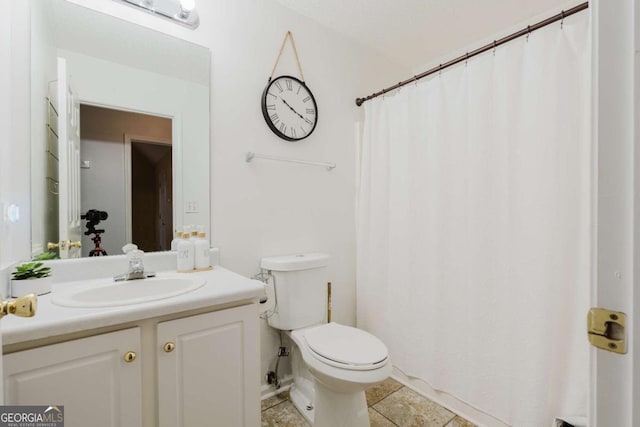 bathroom with vanity, tile patterned floors, and toilet