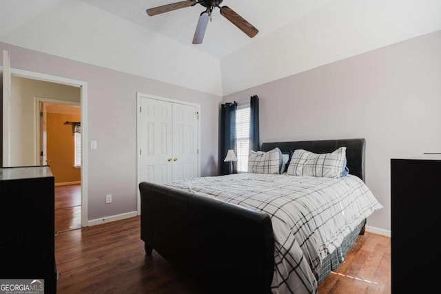 bedroom with lofted ceiling, hardwood / wood-style flooring, a closet, and ceiling fan