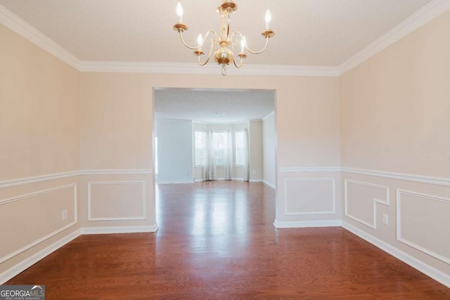 unfurnished dining area featuring ornamental molding, hardwood / wood-style floors, and a notable chandelier