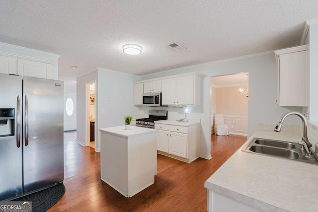 kitchen featuring wood-type flooring, appliances with stainless steel finishes, sink, and white cabinets