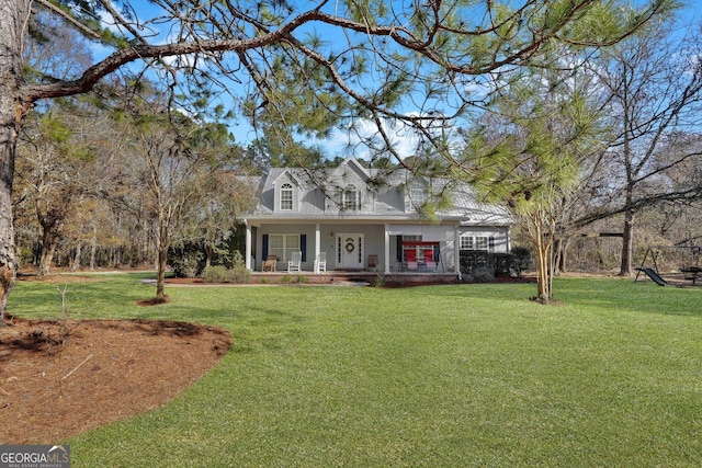 cape cod home featuring a front yard and a porch