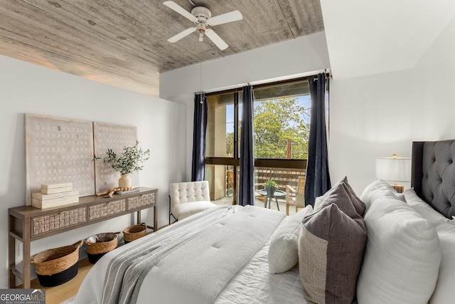 bedroom featuring hardwood / wood-style floors, access to exterior, and ceiling fan