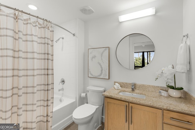 full bathroom with vanity, shower / tub combo with curtain, and toilet