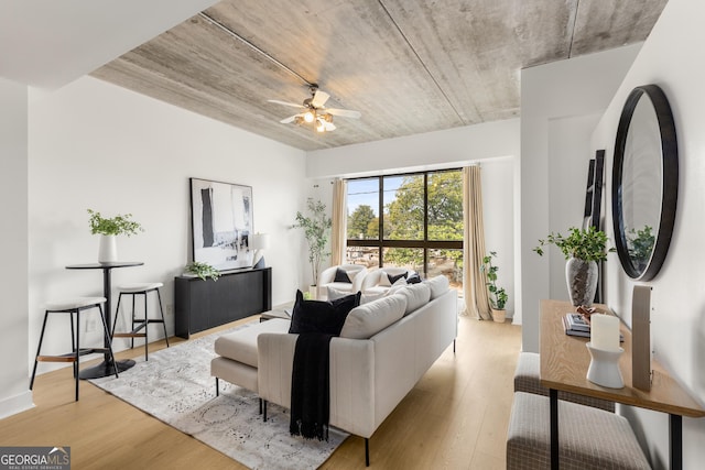 living room with ceiling fan and light wood-type flooring