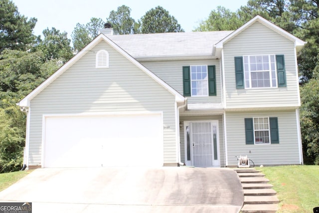 view of front facade featuring driveway, a chimney, and an attached garage