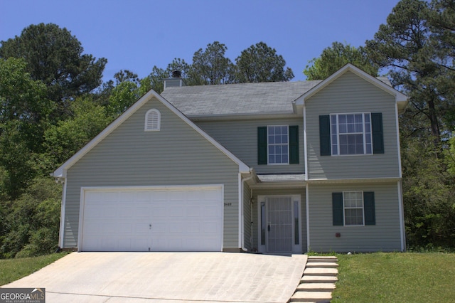 traditional-style house with a front lawn, driveway, a chimney, and a garage