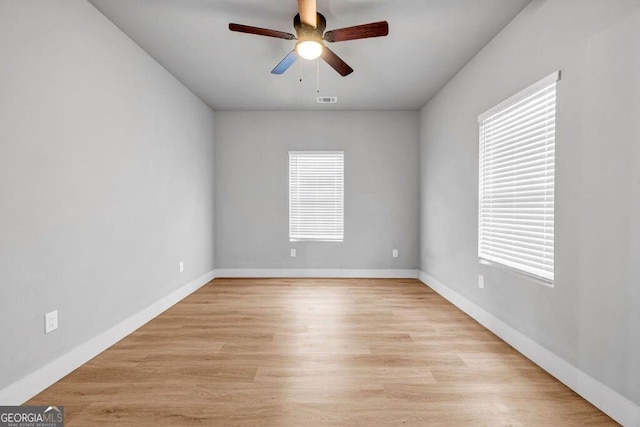 spare room with light hardwood / wood-style floors and ceiling fan