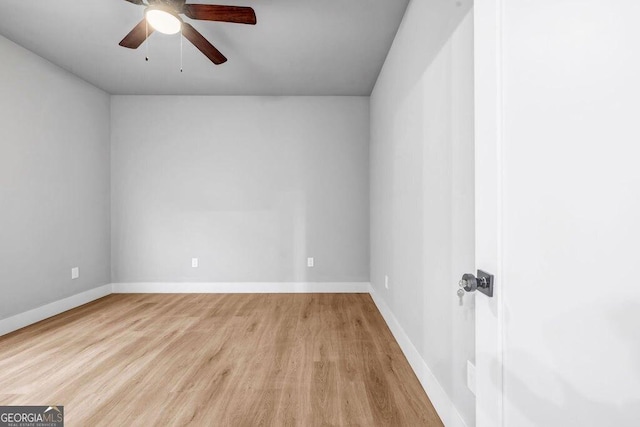 empty room featuring ceiling fan and light hardwood / wood-style flooring