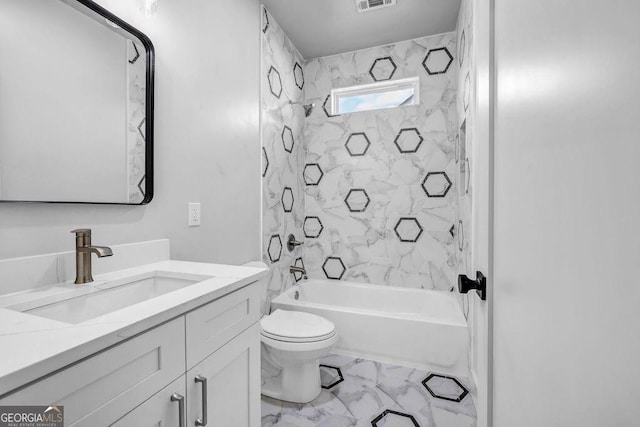 full bathroom featuring tiled shower / bath, vanity, and toilet