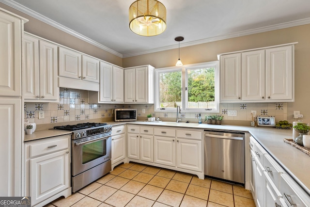 kitchen featuring crown molding, tasteful backsplash, decorative light fixtures, appliances with stainless steel finishes, and white cabinets