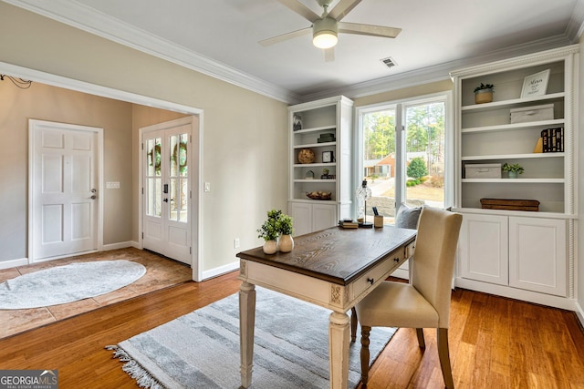 home office featuring wood-type flooring, ornamental molding, and ceiling fan