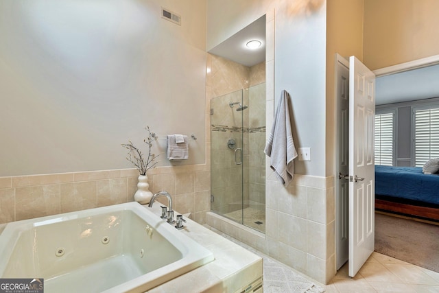 bathroom featuring independent shower and bath and tile patterned flooring