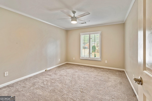 empty room with ornamental molding, carpet floors, and ceiling fan