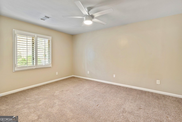 carpeted empty room featuring ceiling fan