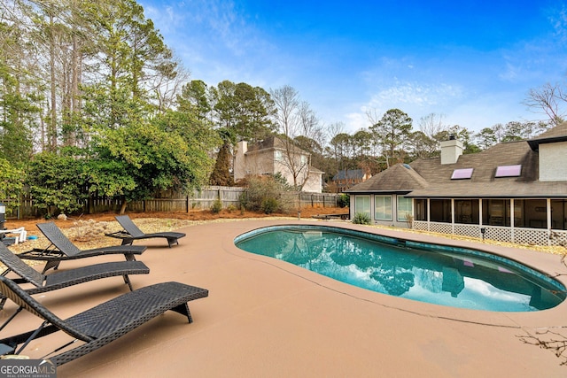 view of pool with a patio area and a sunroom