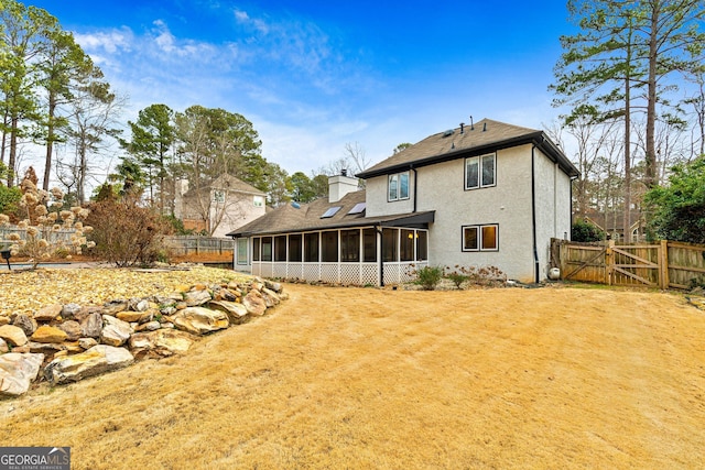 rear view of property with a sunroom