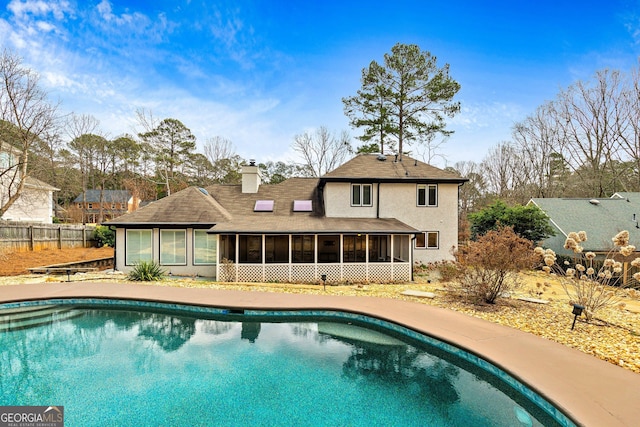 view of pool featuring a sunroom