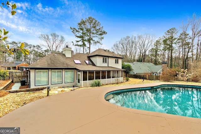 view of swimming pool featuring a sunroom and central AC