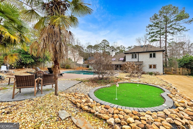 surrounding community featuring a pool, an outdoor living space, and a patio area