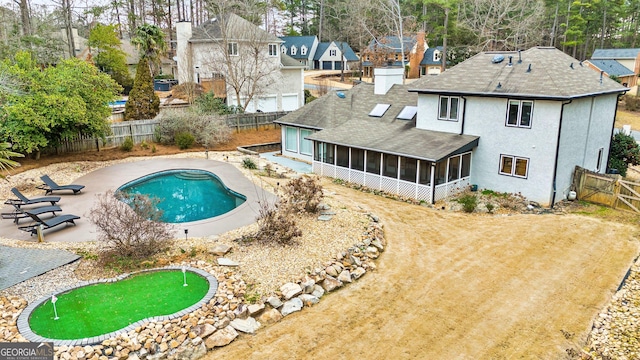 view of pool with a sunroom and a patio area