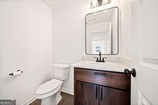 bathroom featuring vanity and toilet