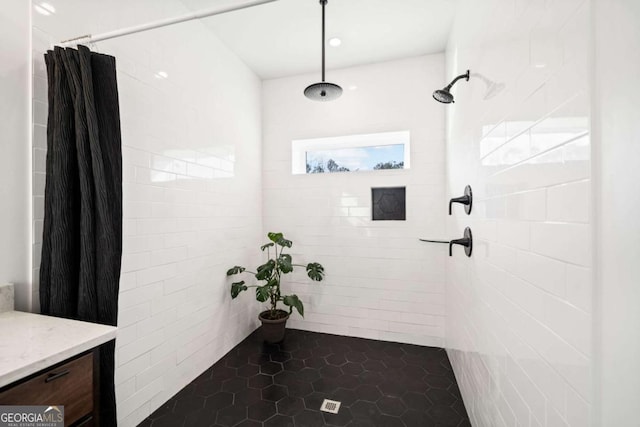 bathroom with walk in shower and vanity