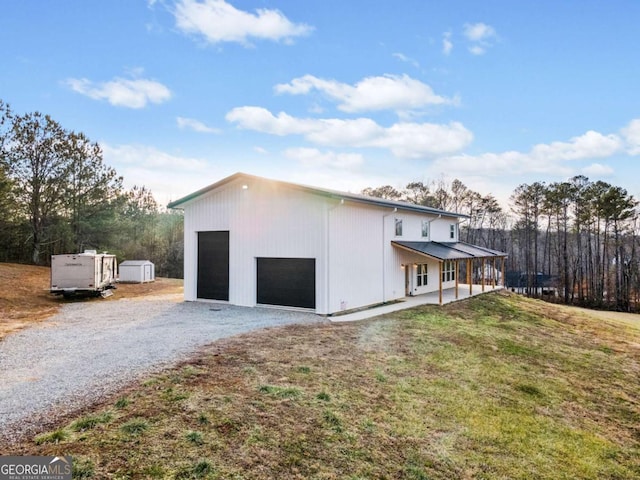 view of home's exterior with a storage shed, a yard, and covered porch