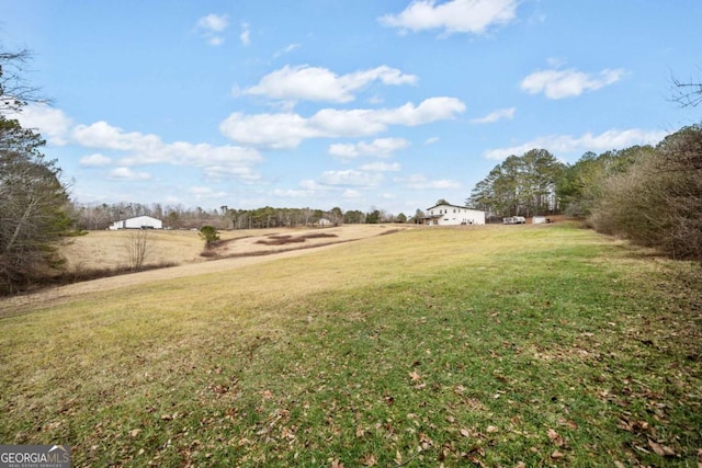 view of yard with a rural view