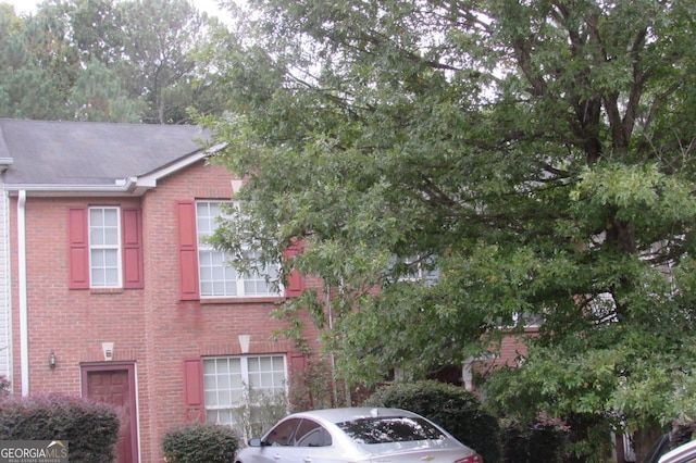 view of side of property featuring brick siding