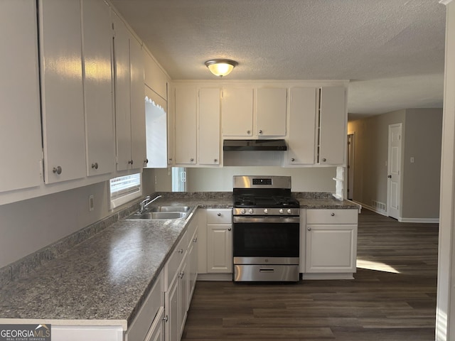 kitchen featuring dark hardwood / wood-style floors, stainless steel gas stove, white cabinetry, sink, and a textured ceiling