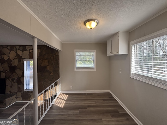 bedroom with dark hardwood / wood-style floors and a textured ceiling