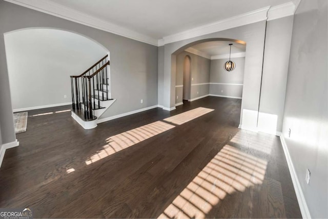 empty room featuring crown molding and dark hardwood / wood-style floors