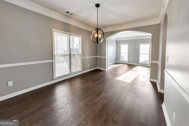 spare room with crown molding, dark hardwood / wood-style floors, and a wealth of natural light