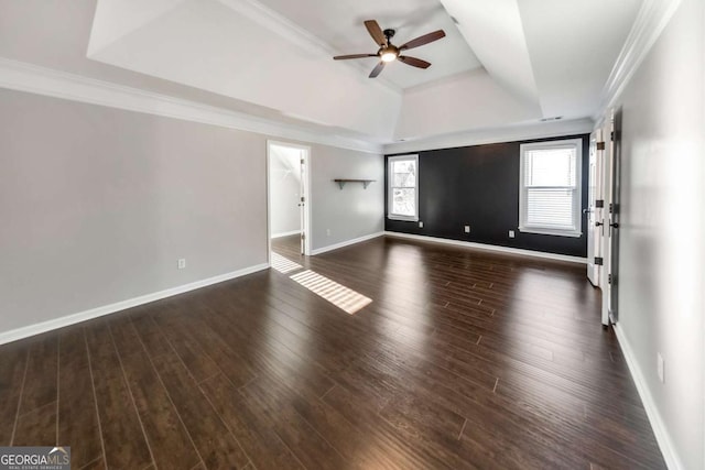 spare room featuring crown molding, ceiling fan, dark hardwood / wood-style floors, and a raised ceiling