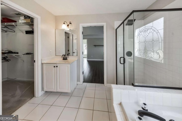 bathroom with tile patterned floors, vanity, and separate shower and tub