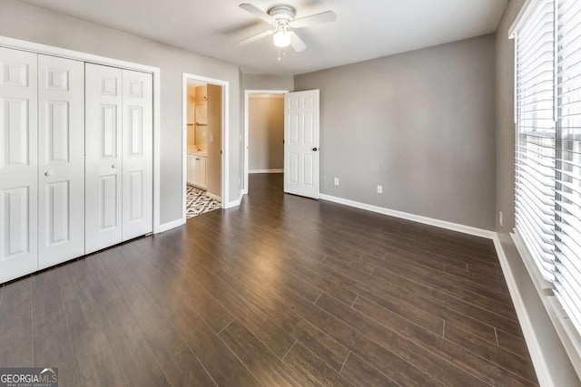 unfurnished bedroom featuring ceiling fan, dark hardwood / wood-style flooring, and a closet