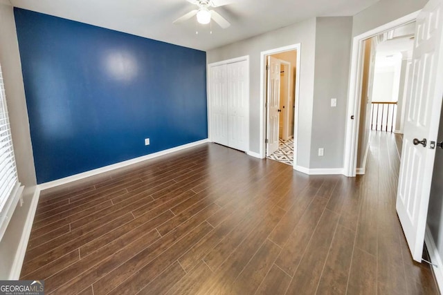 unfurnished room with ceiling fan and dark hardwood / wood-style flooring