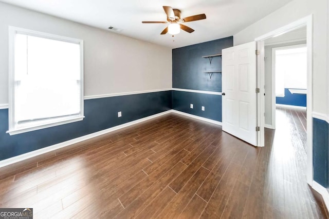 unfurnished room featuring dark hardwood / wood-style floors and ceiling fan