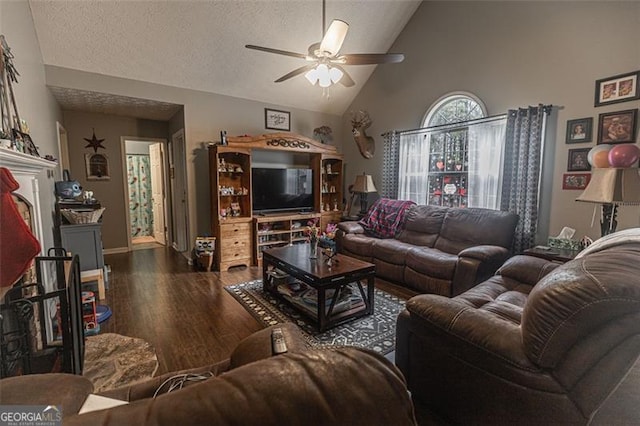 living room with ceiling fan, dark hardwood / wood-style flooring, high vaulted ceiling, and a textured ceiling