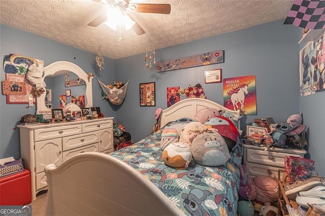 bedroom featuring ceiling fan, carpet flooring, and a textured ceiling