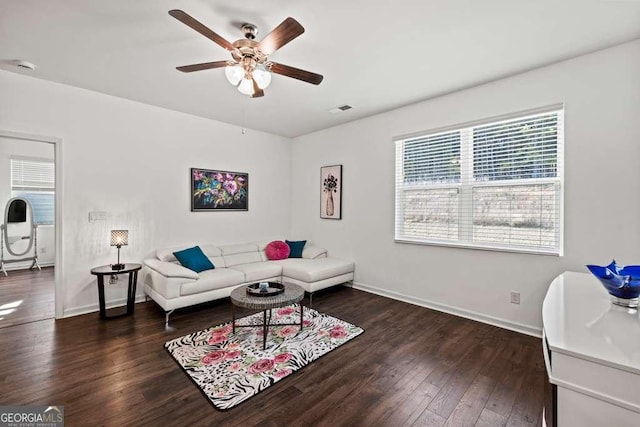 living room with ceiling fan and dark hardwood / wood-style flooring