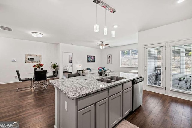 kitchen with pendant lighting, sink, gray cabinetry, a center island with sink, and stainless steel dishwasher